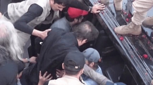 Television footage showed Imran Khan being hustled into a car after the shots were fired. (Photo Credit: Dawn)