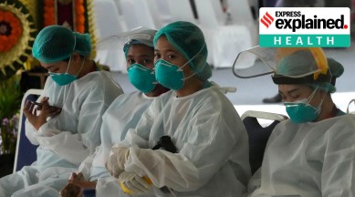 Health workers wait to give delegate members COVID tests during the B20 Summit ahead of the G20 leaders summit in Nusa Dua, Bali, Indonesia, Sunday, Nov. 13, 2022.