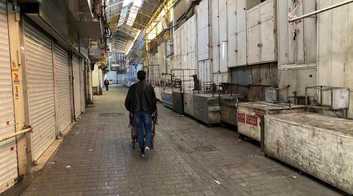A man pushes his cart past closed shops of Tehran's Grand Bazaar, Iran, Nov. 15, 2022. (AP)