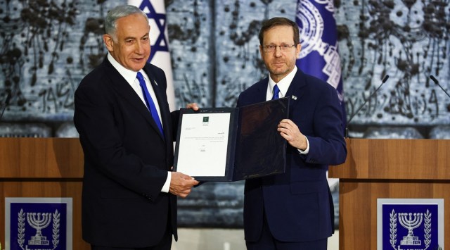 Israel President Isaac Herzog hands Benjamin Netanyahu the mandate to form a new government following the victory of the former premier's right-wing alliance in this month's election at the President's residency in Jerusalem November 13, 2022. (REUTERS)