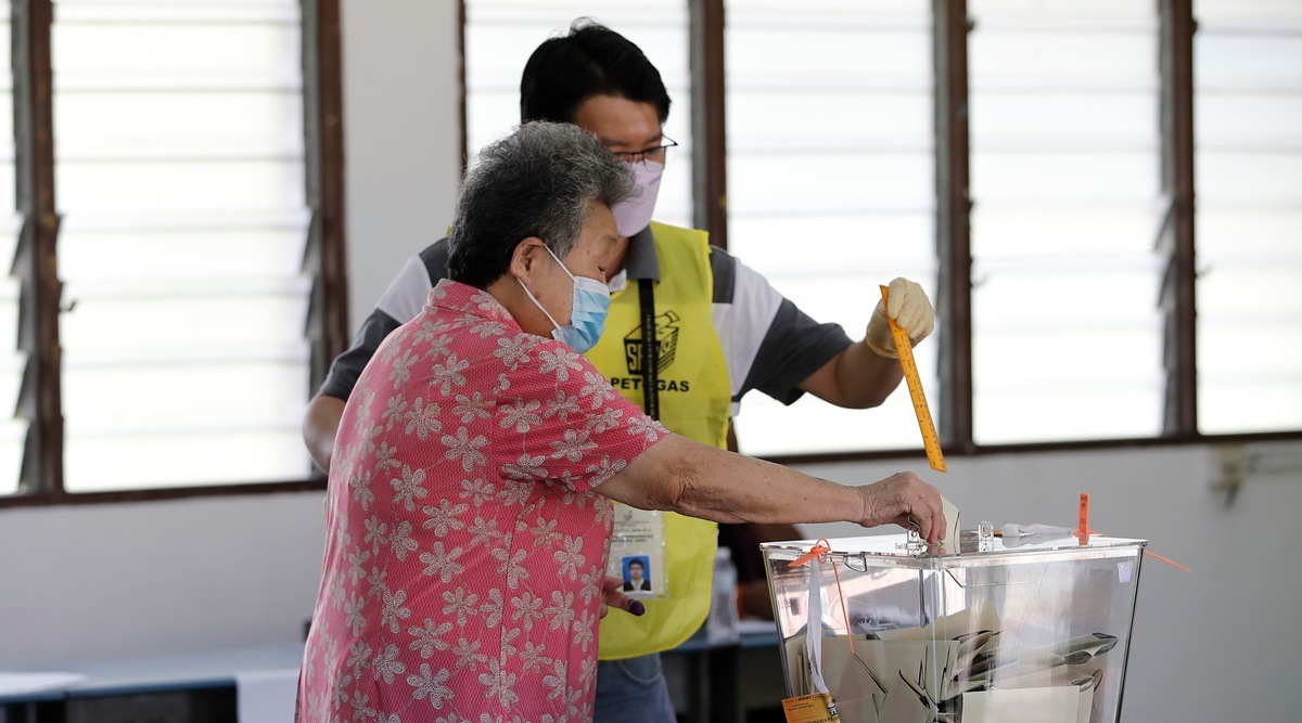 An elderly Malaysian voter casts her ballot for the general elections at a polling station in Kuala Lumpur, Malaysia, Saturday, Nov. 19, 2022. (AP Photo)