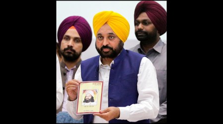 Punjab Chief Minister Bhagwant Mann releases a book during an event dedicated to Punjabi language, organised at the Guru Nanak Dev University in Amritsar, Saturday, Nov. 19, 2022. (PTI Photo)