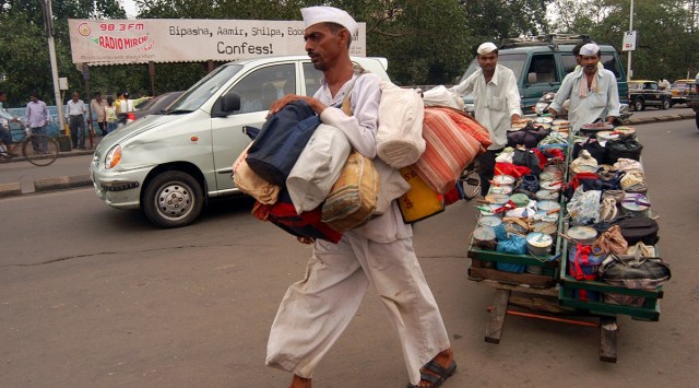 Mumbai dabbawalas on way at lower parcel station in Mumbai to deliver food on 23/09/2005. (Express archive photo by Pradeep Kochrekar)