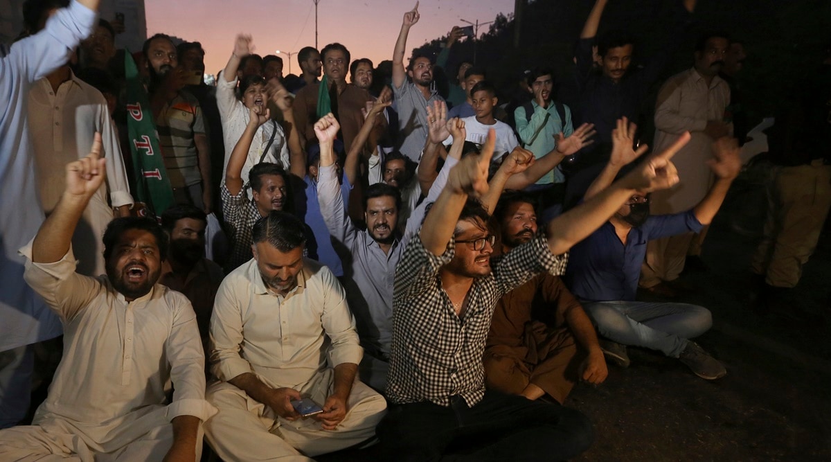 Supporters of former Pakistani Prime Minister Imran Khan's party, Pakistan Tehreek-e-Insaf, chant slogans as they block a road during a protest to condemn a shooting incident on their leader's convoy, in Karachi, Pakistan, Thursday, Nov. 3, 2022. A gunman opened fire Thursday at a campaign truck carrying Khan, wounding him slightly in the leg and killing one of his supporters, his party and police said. Nine others were also wounded.(AP/PTI)