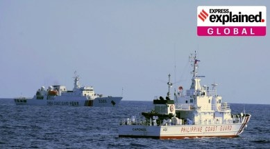 a Chinese Coast Guard ship sails near a Philippine Coast Guard vessel.