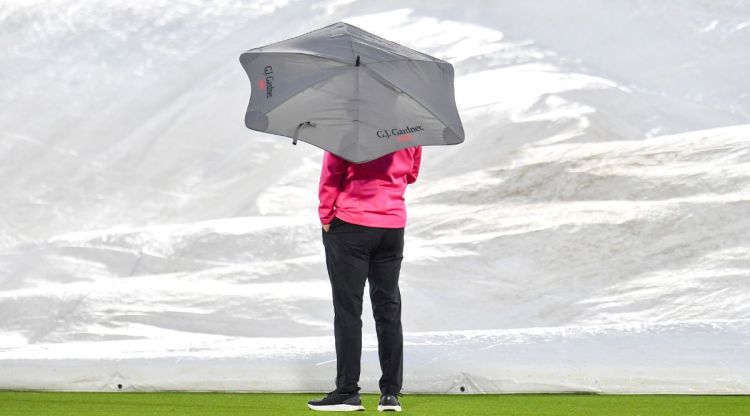 Umpire Wayne Knights looks on as the covers are placed over the wicket as rain stops play during the one day cricket international between India and New Zealand at Hagley Oval, in Christchurch, New Zealand, Wednesday, Nov. 30, 2022. (John Davidson/Photosport via AP)
