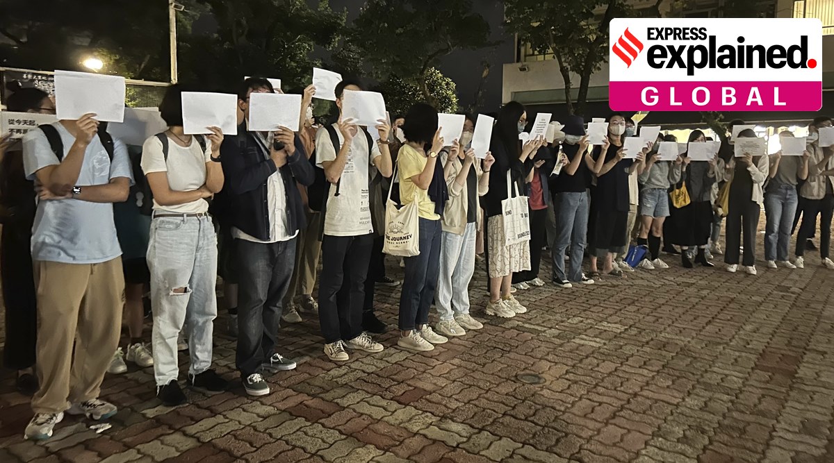Protesters hold up blank white papers during a commemoration for victims of a recent Urumqi deadly fire at the Chinese University of Hong Kong in Hong Kong, on Monday, November 28, 2022. (AP Photo)