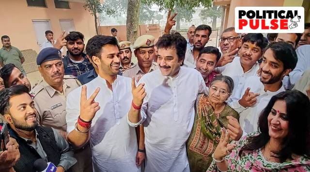 BJP leader Kuldeep Bishnoi with son Bhavya Bishnoi flash their ink-marked fingers after casting their votes for the Adampur Assembly by-elections on Nov. 3, 2022. (PTI Photo)
