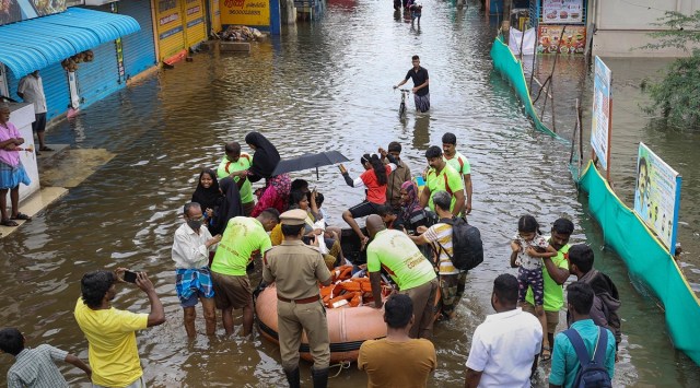 Tamil Nadu Fire and Rescue Services (TNFRS) personnel evacuate people from a waterlogged residential area following heavy rains, near Chennai, Sunday, (PTI)