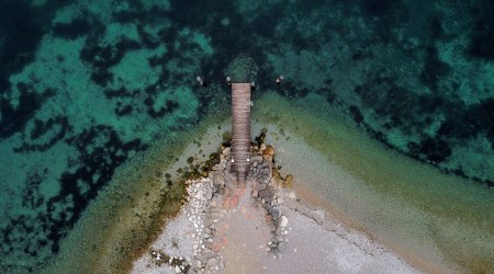 The shallow water is seen next to a boat dock at lake Garda near Malcesine, northern Italy, Nov. 1, 2022. (AP)
