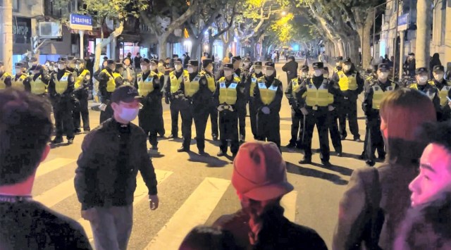 Chinese police officers block off access to a site where protesters had gathered in Shanghai on Sunday, Nov. 27, 2022. (AP/PTI)