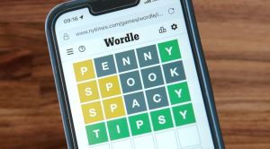 table with a smartphone kept on top, in which wordle is being played