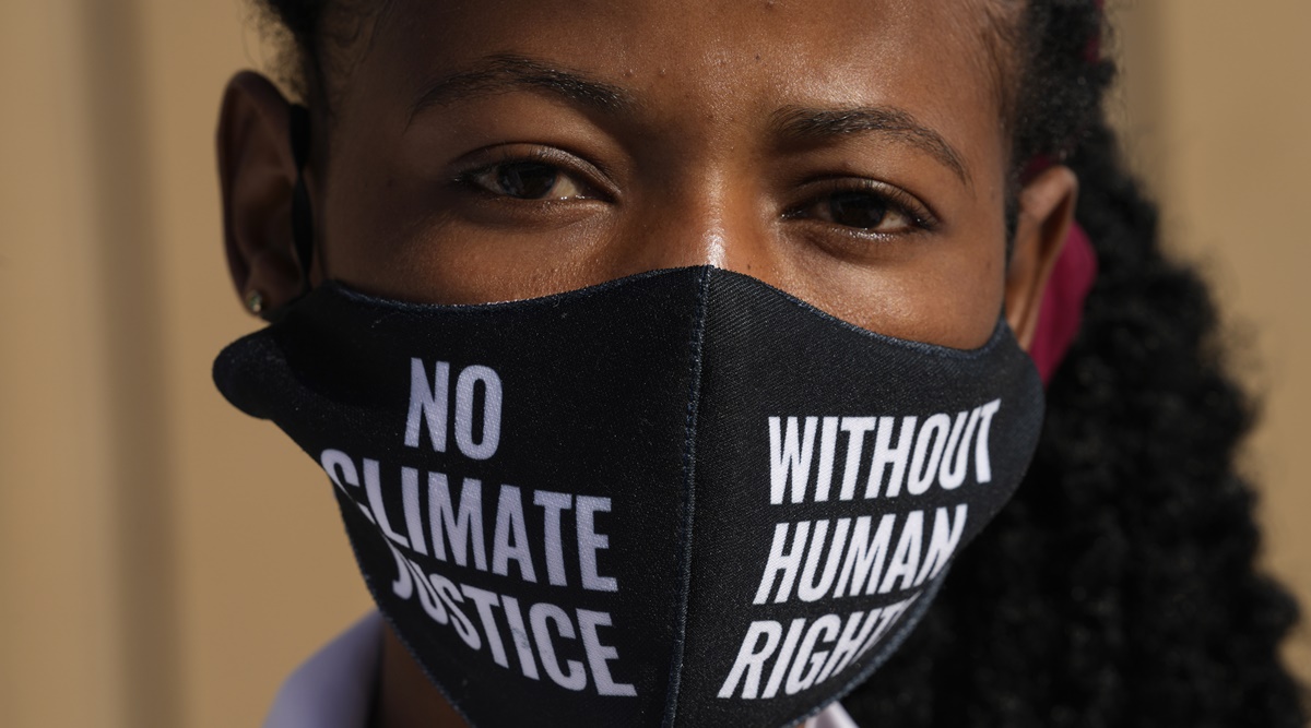 A woman wears a face mask that reads "no climate justice without human rights" during a silent protest for climate justice at the COP27 U.N. Climate Summit, Thursday, Nov. 10, 2022, in Sharm el-Sheikh, Egypt. (AP Photo)