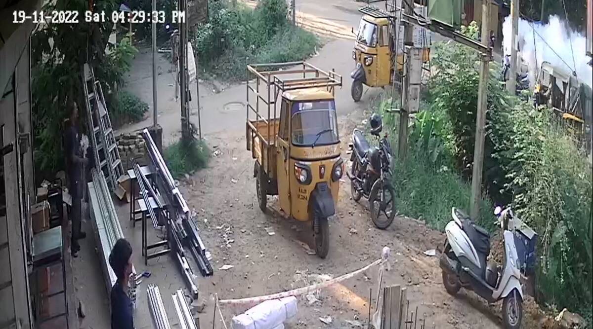 Smoke rises (on extreme right) after an autorickshaw on a street, as seen from a CCTV camera from a nearby area, in Mangaluru city. (PTI)