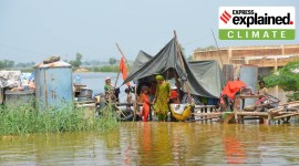 A family in a makeshift tent surrounded by flood water during the Pakistan floods.