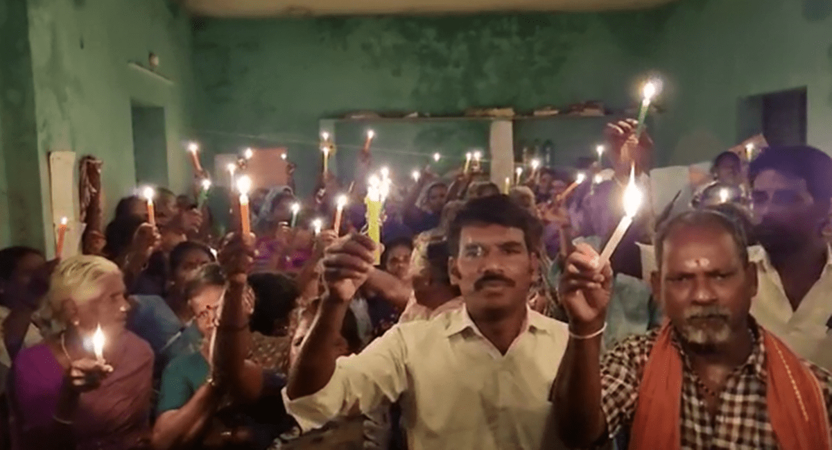 Residents of Ekanapuram and other surrounding villages holding candles on 4/11/22, Friday to mark their protest against the construction of airport as they do not want to vacate their lands (Express photo)
