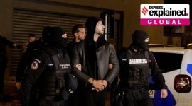 Andrew Tate and Tristan Tate are escorted by police.