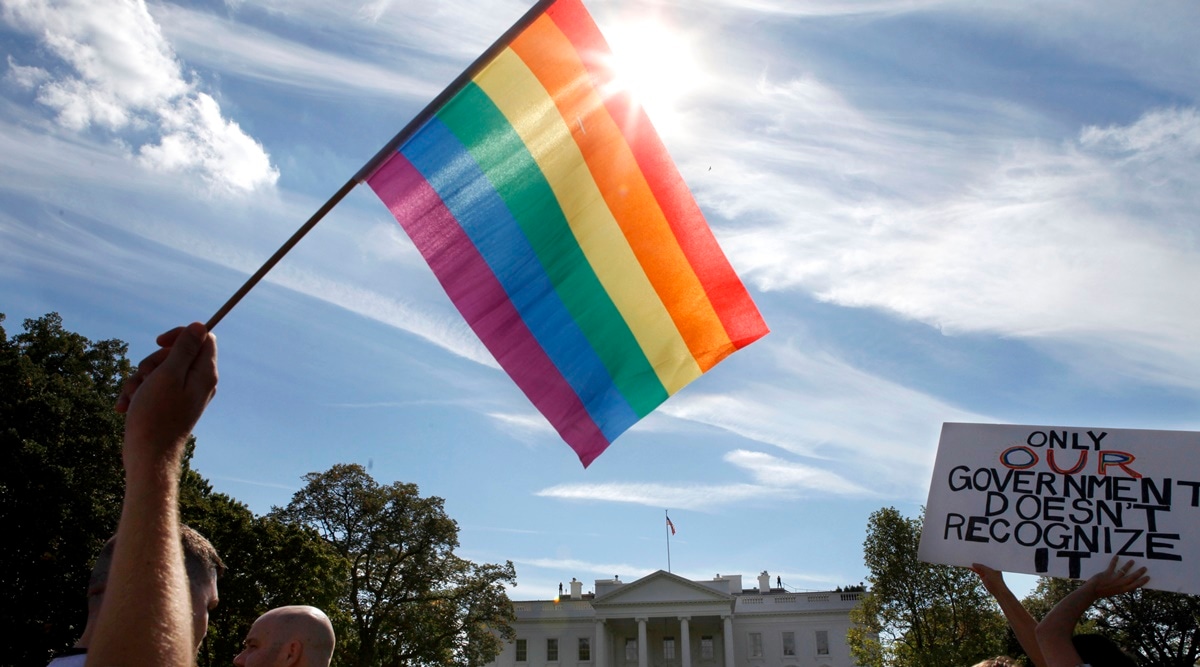 Gay rights advocates march by the White House in Washington, on Sunday, Oct. 11, 2009. President Joe Biden plans to sign legislation this coming week that will protect gay unions even if the Supreme Court revisits its ruling supporting a nationwide right of same-sex couples to marry. (AP Photo/File)