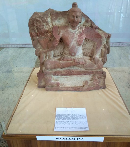 A Bodhisattva statue showing a sitting pose.