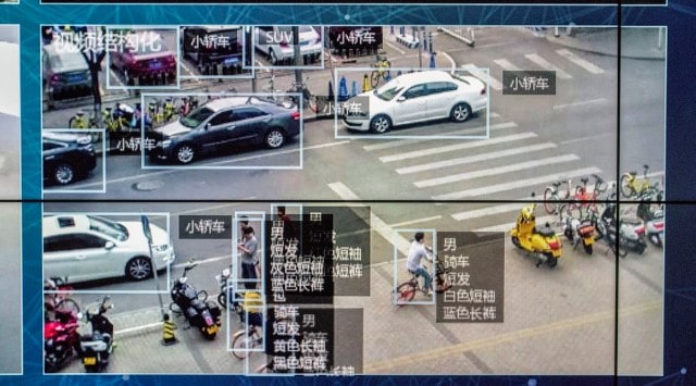 A monitor displays video showing identification software in use at a Beijing showroom on May 10, 2018. The software allowed identification of pedestrians by gender, type of hair, clothes, etc. Types of cars driving by were also identified.  (Gilles Sabri/The New York Times)