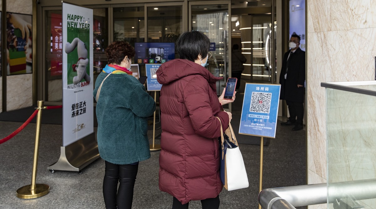 Shoppers scan a health tracking code before entering a mall in the Lujiazui financial district of Shanghai, China, on Thursday (New York Times)