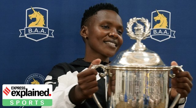 Diana Kipyokei, of Kenya, holds a Boston Marathon championship trophy following a news conference, on Oct. 12, 2021, in Boston. (AP File Photo)
