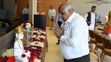 Gujarat Chief Minister Bhupendra Patel offers prayers before Simandhar Swami while taking charge in his office. Express