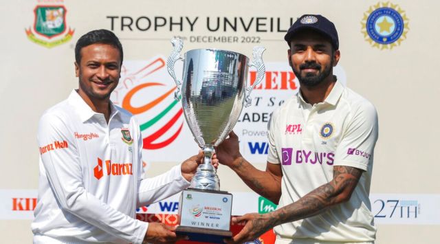 Bangladesh captain Shakib Al Hasan left and Indian captain K.L. Rahul right pose with the test trophy ahead of their first test cricket match in Chattogram, Bangladesh, Monday, Dec. 12, 2022. (AP Photo/Surjeet Yadav)