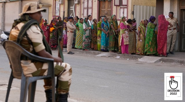 People stand in queue to cast their votes during the first phase of Gujarat state legislature elections in Wadhwan, December 1, 2022. (AP)
