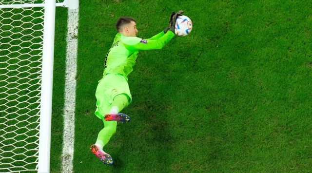 Croatia's goalkeeper Dominik Livakovic saves a shot during a penalty shootout during the World Cup quarterfinal soccer match between Croatia and Brazil, at the Education City Stadium in Al Rayyan, Qatar, Friday, Dec. 9, 2022. (AP)