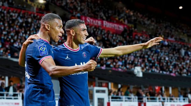 PSG's Kylian Mbappe, left, celebrates with teammate PSG's Achraf Hakimi after scoring his side's second goal during a French League One soccer match between Brest and PSG at the Francis-Le Ble stadium in Brest, France. (AP)