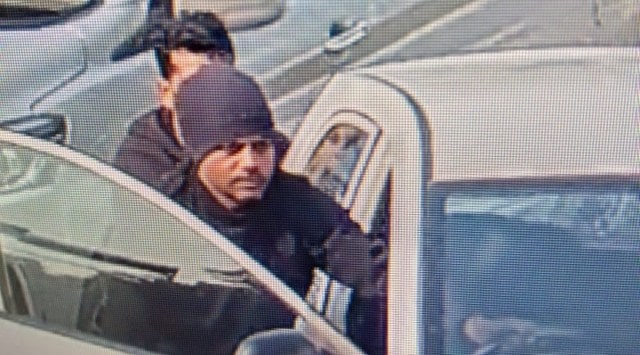 A CCTV camera grab shows the men pushing the car. 
