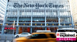 Vehicles drive past the New York Times headquarters in New York