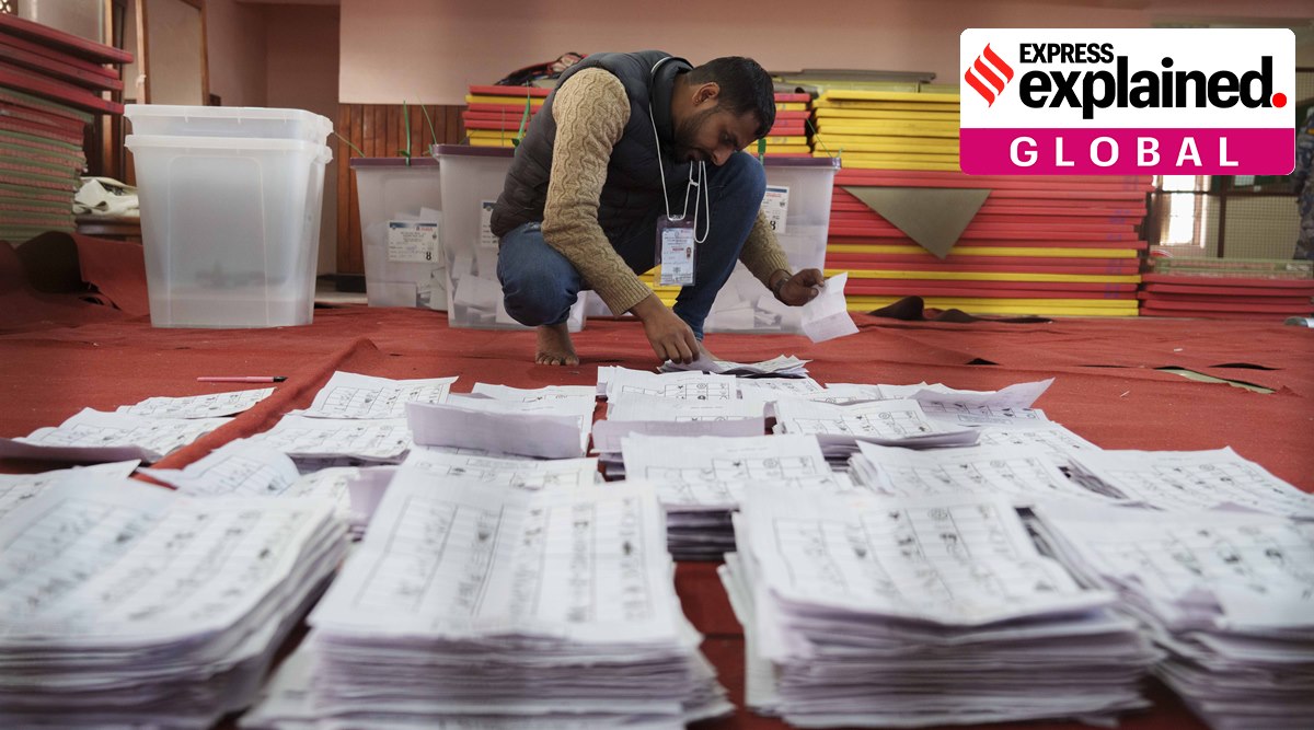 An election commission staff separates ballot papers to count a day after the general election in Kathmandu, Nepal, Nov. 21, 2022. (AP Photo/Niranjan Shrestha, File)
