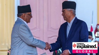 Pushpa Kamal Dahal, left, is congratulated by former prime minister Sher Bahadur Deuba