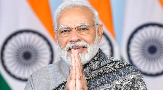 Prime Minister Narendra Modi greets as he addresses Amrit Mahotsav at Shree Swaminarayan Gurukul Rajkot Sansthan via video conferencing from New Delhi, December 24, 2022. (PTI)