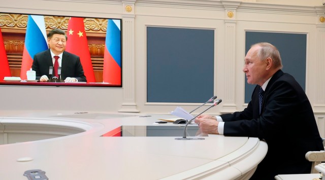 Russian President Vladimir Putin speaks during a meeting with Chinese President Xi Jinping, seen onscreen, via a video conference at the Kremlin in Moscow. (AP)
