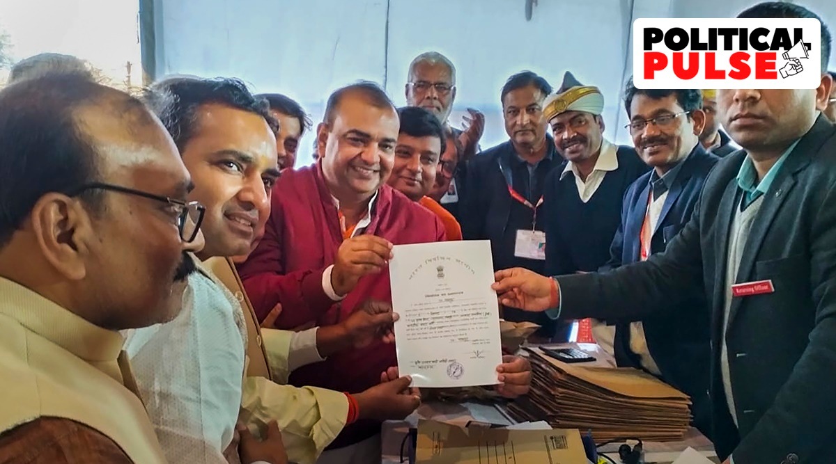 BJP candidate Akash Saxena (in red) receives the 'Certificate of Election' after winning the Rampur Assembly by-elections, in Rampur. (PTI)