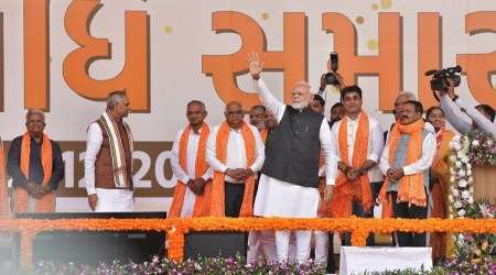 Prime Minister Narendra Modi with Gujarat Governor Acharya Devvrat and newly sworn-in Chief Minister Bhupendra Patel in Gandhinagar on Monday. (Express Photo by Nirmal Harindran)