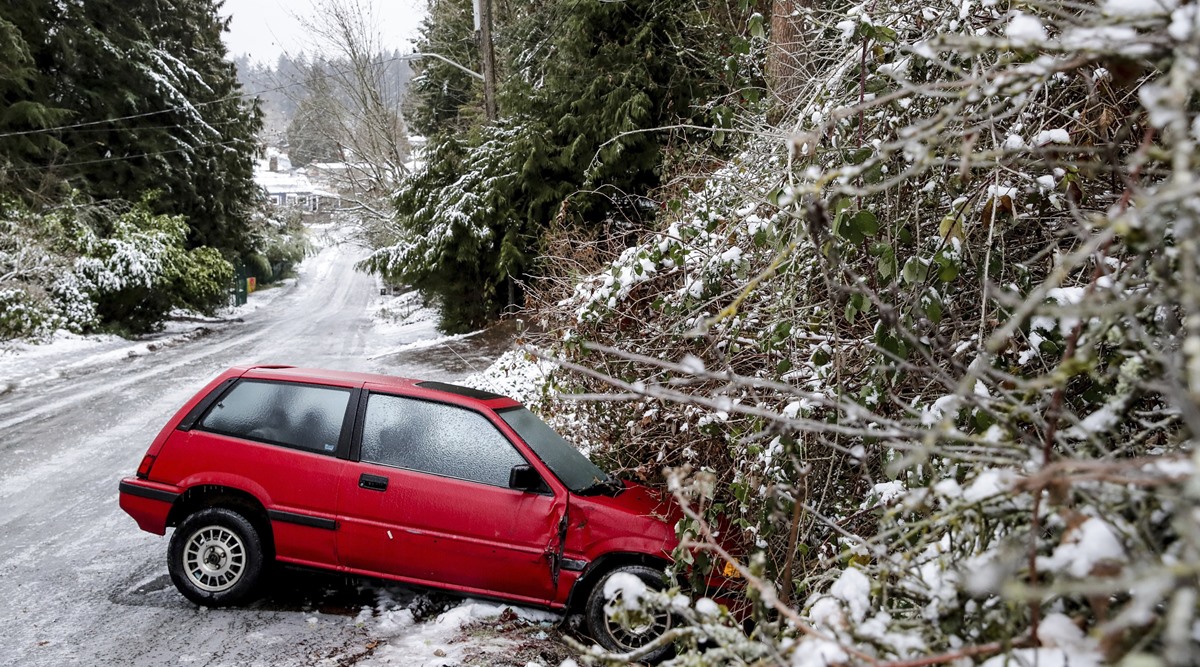 A car is left on the side of the road due to dangerous road conditions, Dec. 23, 2022 in Seattle. (AP)