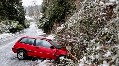 A car is left on the side of the road due to dangerous road conditions, Dec. 23, 2022 in Seattle. (AP)