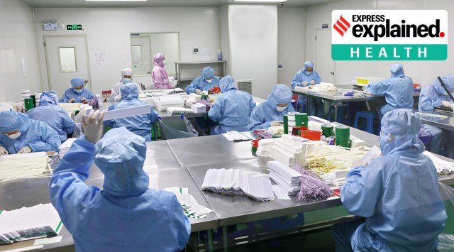 Workers manufacture antigen testing kits for Covid-19 at a workshop in Jiangsu province,on Monday. (Reuters)