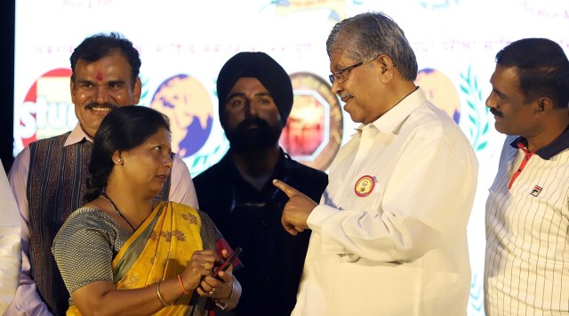 Maharashtra's Higher and Technical Education Minister Chandrakant Patil and Shivsena Leader Sushma Andhare during the 11th competitive exams literature conference in Tilak Smarak mandir on Sunday. (Express Photo by Pavan Khengre)