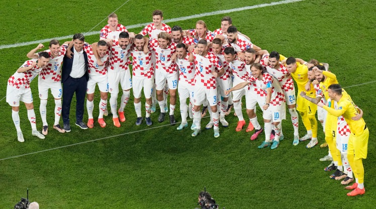 Croatia's head coach Zlatko Dalic, 3rd left, and players pose for photos at the end of the World Cup third-place playoff soccer match between Croatia and Morocco at Khalifa International Stadium in Doha, Qatar, Saturday, Dec. 17, 2022. Croatia won 2-1. (AP Photo/Pavel Golovkin)