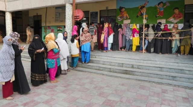 Voters wait to cast their votes for the MCD elections, at a polling station, in East Delhi, Sunday, Dec. 4, 2022. (PTI Photo)