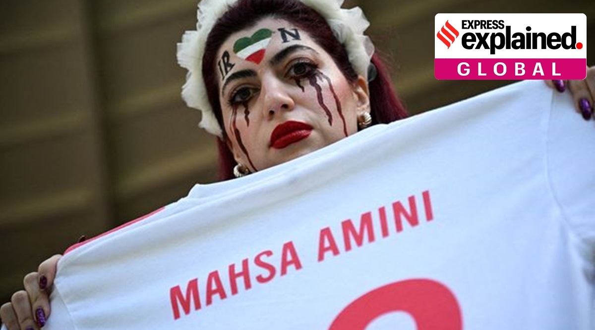 An Iranian fan holds a jersey in memory of Mahsa Amini at the World Cup in Qatar last month.  (Reuters file)