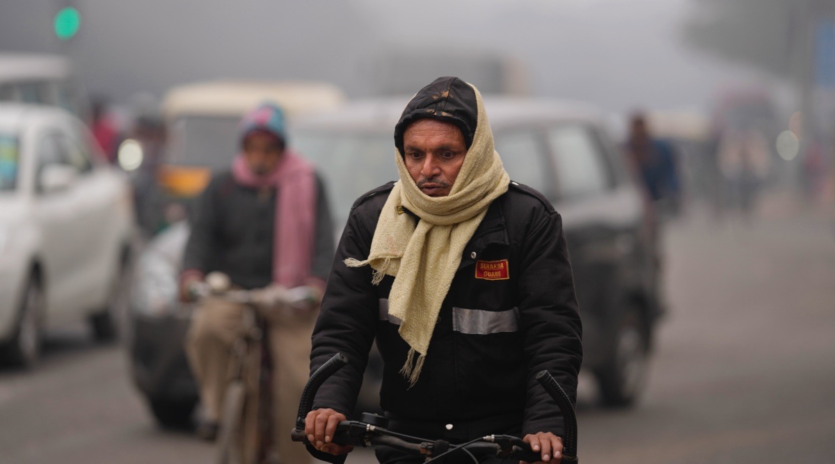 A cyclist wearing warm clothing rides on a cold and foggy morning in New Delhi, India. (AP Photo)