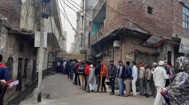 Long queues outside a polling booth in Northeast Delhi's Brijpuri on Sunday, December 4, 2022. (Express Photo)