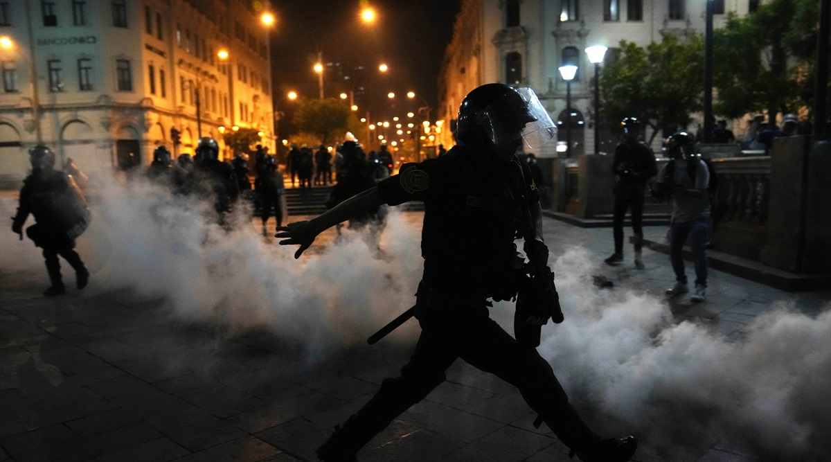 Tear gas is returned to police trying to break up supporters of ousted President Pedro Castillo at plaza San Martin in Lima, Peru (AP)
