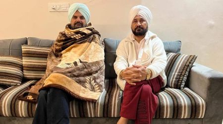 Former Punjab CM Charanjit Singh Channi with Balkaur Singh, father of Sidhu Moosewala, at Moosa village on Wednesday.